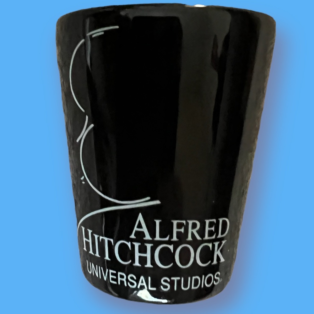 Vintage Shot Glass Alfred Hitchcock Universal Studios Black Glass.  Nice item.